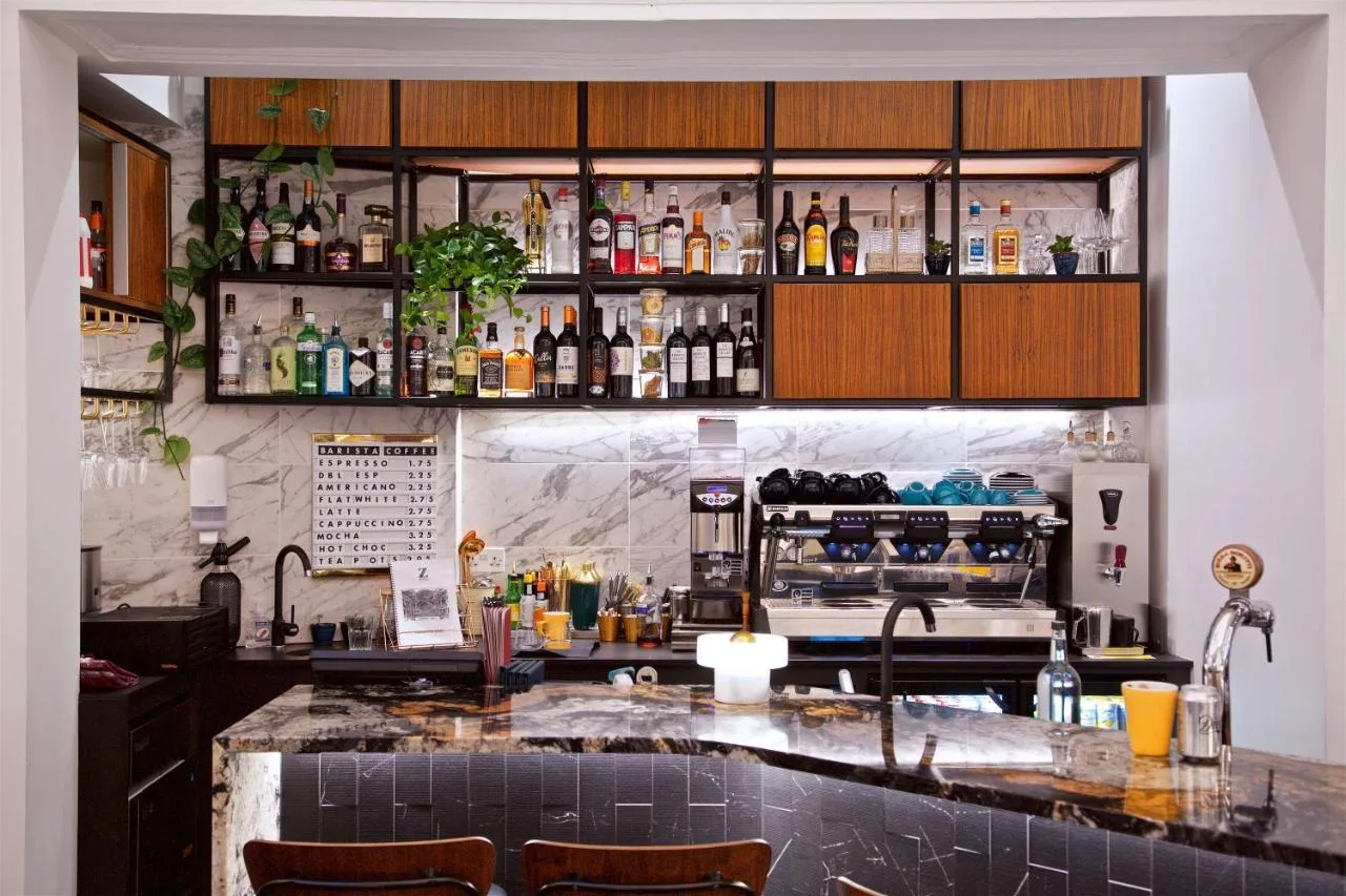 Hotel bar with bottles on the wall at The Z Hotel Holborn