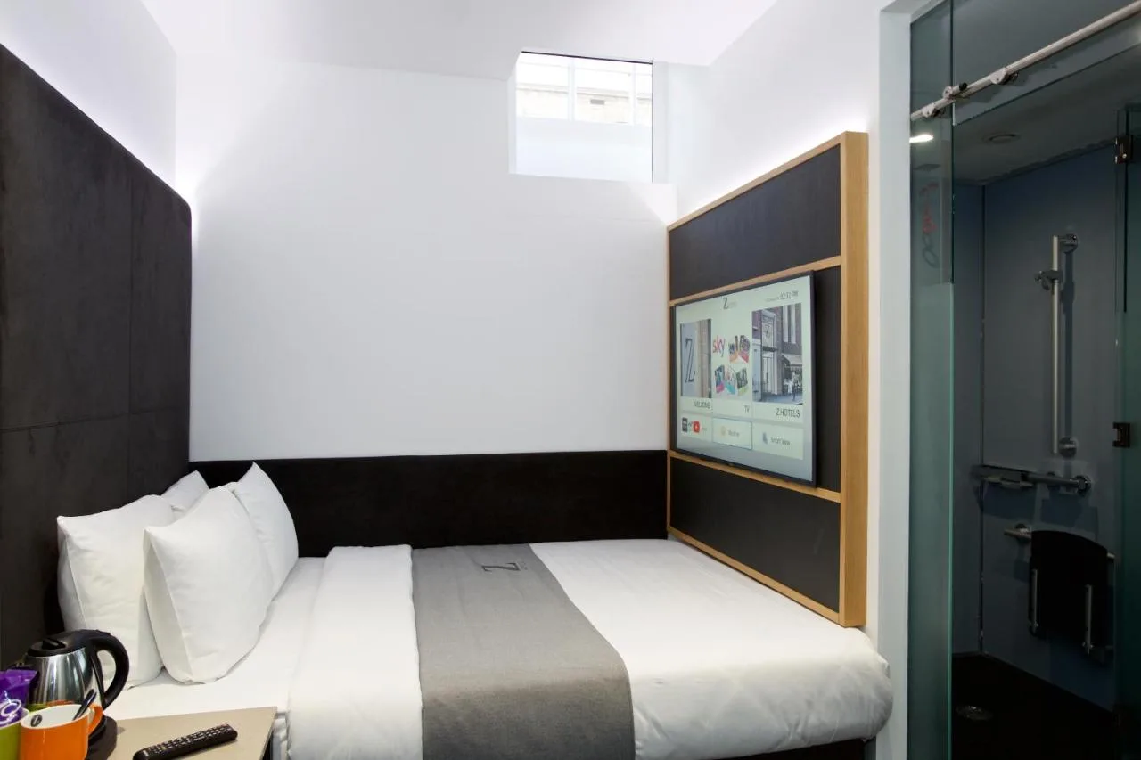 Hotel room with bed and television at The Z Hotel Holborn